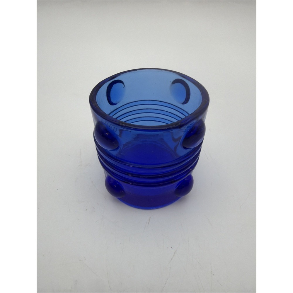vibrant cobalt blue glass piece with a ridged center and raised dot details